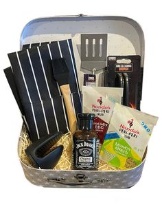 an open suitcase filled with cooking supplies and utensils