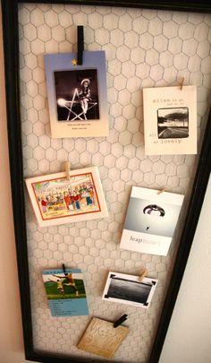 a bulletin board with pictures and magnets attached to it's sides, hanging on a wall