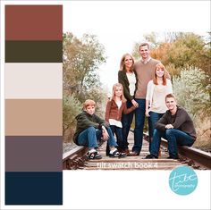 a family posing for a photo on train tracks with trees in the background and text overlay