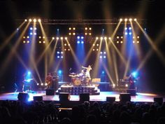 an image of a concert scene with lights on the stage and people in the audience