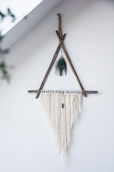 an image of a wall hanging made out of sticks and fringes with the words hummusbird on it