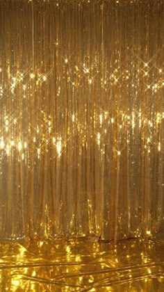 gold curtain with lights shining down on it