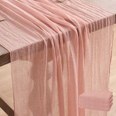 a table with a pink cloth draped over it