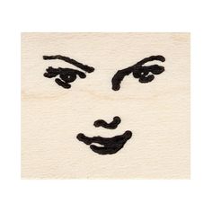 the face of a woman with black hair and eyes is drawn on a white surface