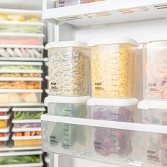 an open refrigerator filled with lots of food and containers on the shelves in front of it