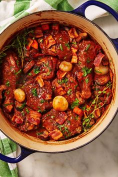 a pot filled with meat and vegetables on top of a table