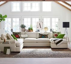 a living room filled with furniture and lots of windows