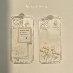 two clear cases with flowers on them sitting next to each other