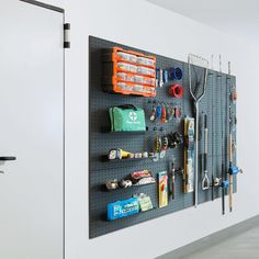 there is a wall mounted tool rack with tools on it