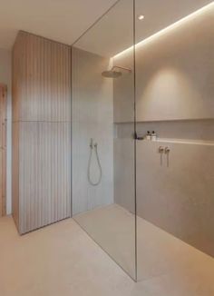 a bathroom with a shower, sink and mirror on the wall next to each other