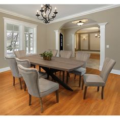 a dining room table with six chairs and a chandelier