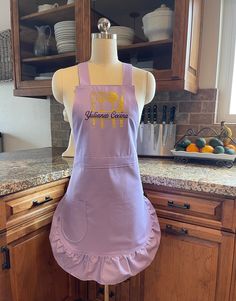 an apron on a mannequin in a kitchen