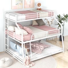 a white bunk bed with pink sheets and pillows on top of it, next to a potted plant