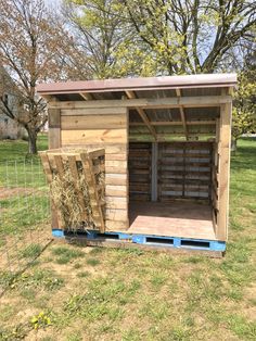 a small shed with hay in the back