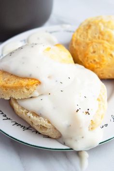 two biscuits covered in white icing sit on a plate