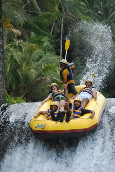 a group of men riding on the back of a raft down a river