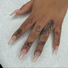 a woman's hand with some tattoos on it