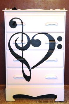 a white dresser with a musical note painted on it