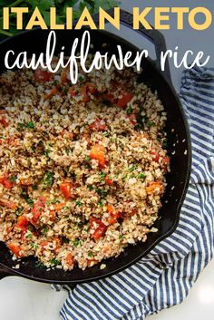 a skillet filled with rice and vegetables on top of a blue and white towel