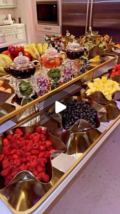 a buffet table filled with lots of different types of fruit and vegtables