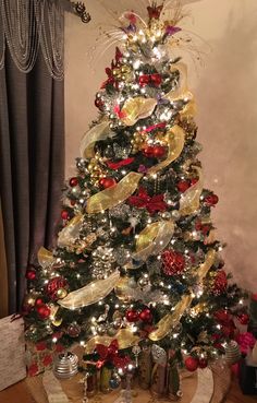 a christmas tree decorated with ribbons and ornaments