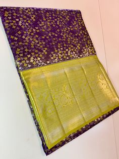 a purple and yellow sari with gold designs on it