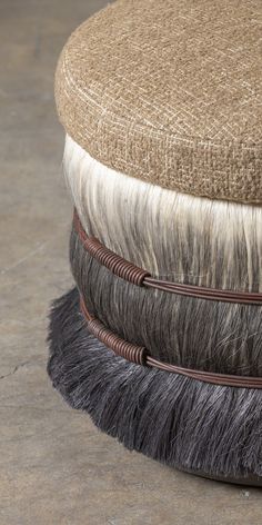 a close up of a cushion on the floor with hair around it's edges