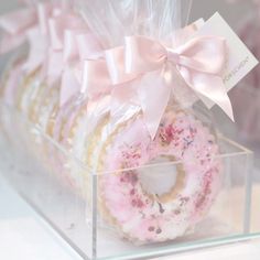 a box filled with donuts covered in frosting and pink sprinkles