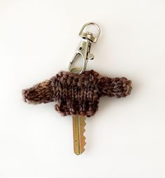 a knitted keychain with a pair of scissors attached to the end of it