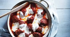 meatballs and sauce in a pan on a table