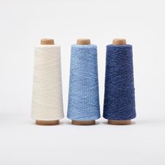 three spools of thread sitting next to each other