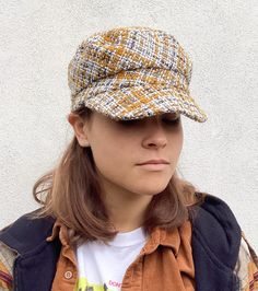 This tweed recycled wool cap in colours of yellow ochre, grey and cream will add style to any outfit. It is fully lined in brown cotton and has an inner cotton moleskin band for comfort. Size M to fit head size 57cm/22.5 inches * Dry clean only To see more of my hats please click https://www.etsy.com/uk/shop/OverToYou I design, pattern cut and create all my hats in sunny Brighton in the South of England. All my designs are original and combine timeless elegance with a modern twist. I despatch my Cotton Flat Cap For Fall, Cotton Cap For Fall, Beige Cotton Hat For Fall, Brown Cotton Hat For Fall, Brown Cloche Cap For Fall, Brown Tweed Hat For Fall, Trendy Yellow Hats For Fall, Brown Fall Cloche Hat, Trendy Yellow Fall Hat