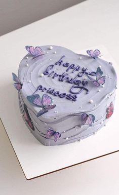 a birthday cake with purple butterflies on it