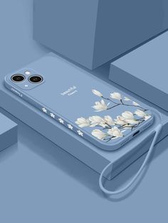 an iphone case with flowers painted on the back and sides, sitting in front of a blue background