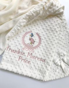 a white towel with the name franbie maresa price on it and a pink ribbon