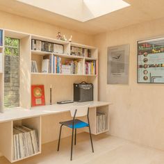 a room with bookshelves, shelves and a desk in the corner that has a computer on it