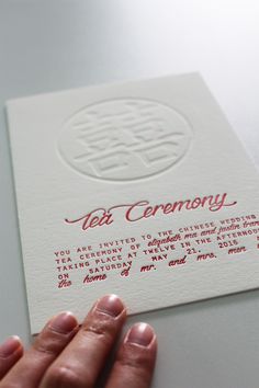 a person holding up a business card with the words tet ceremony written on it