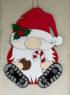 a santa clause sign hanging on the wall