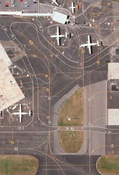 an aerial view of several airplanes on the tarmac