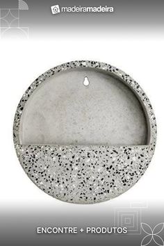 an image of a stone bowl with black speckles on the bottom and white background