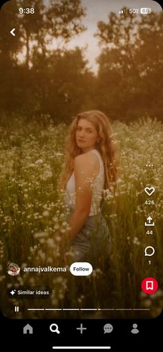 a woman standing in a field with flowers on her head and an instagram sticker above her