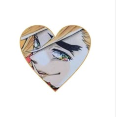 a heart shaped brooch with an image of a woman's face