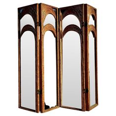 an ornate wooden folding screen with mirrors