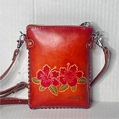 Women’s Rustic Leather, Tooled, Hibiscus Art, Mini Crossbody Bag, Rustic Leather Hawaiian Crossbody Phone Bag With Adjustable Crossbody Or Shoulder Strap. Condition: In Like-New, Clean, Undamaged, Gently Used, Or Unused, Preowned Condition. No Defects. No Flaws. Tags: Women’s Crossbody Bags, Rustic Tooled Leather Phone Bags, Women’s Handbags, Tropical Handbag, Tropical Bags, Women’s Mini Tooled Leather Handbag, Mini Tooled Leather Hawaiian Crossbody Bag, Women’s Bags, Crossbody Bags, Embroidered Small Shoulder Bag For Daily Use, Small Travel Shoulder Bag, Small Pouch For Everyday Use, Small Leather Phone Bag, Rustic Leather Bag, Cognac Leather Bag, Vacation Purse, Tropical Bag, Hibiscus Art