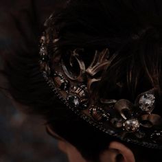 a close up of a person wearing a head piece