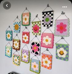 there are many crocheted flowers hanging on the wall