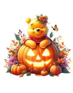 a teddy bear sitting on top of a pumpkin