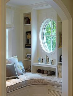 a living room filled with furniture and a round window