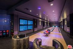 a bowling alley with chairs and bowling balls