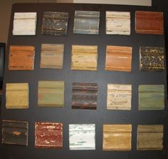 an assortment of paint samples displayed on a black board with white and brown squares in the middle